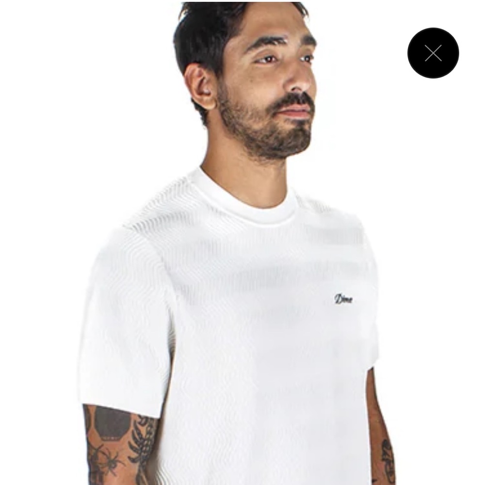 Dime Wave knit shirt in ivory with green logo.